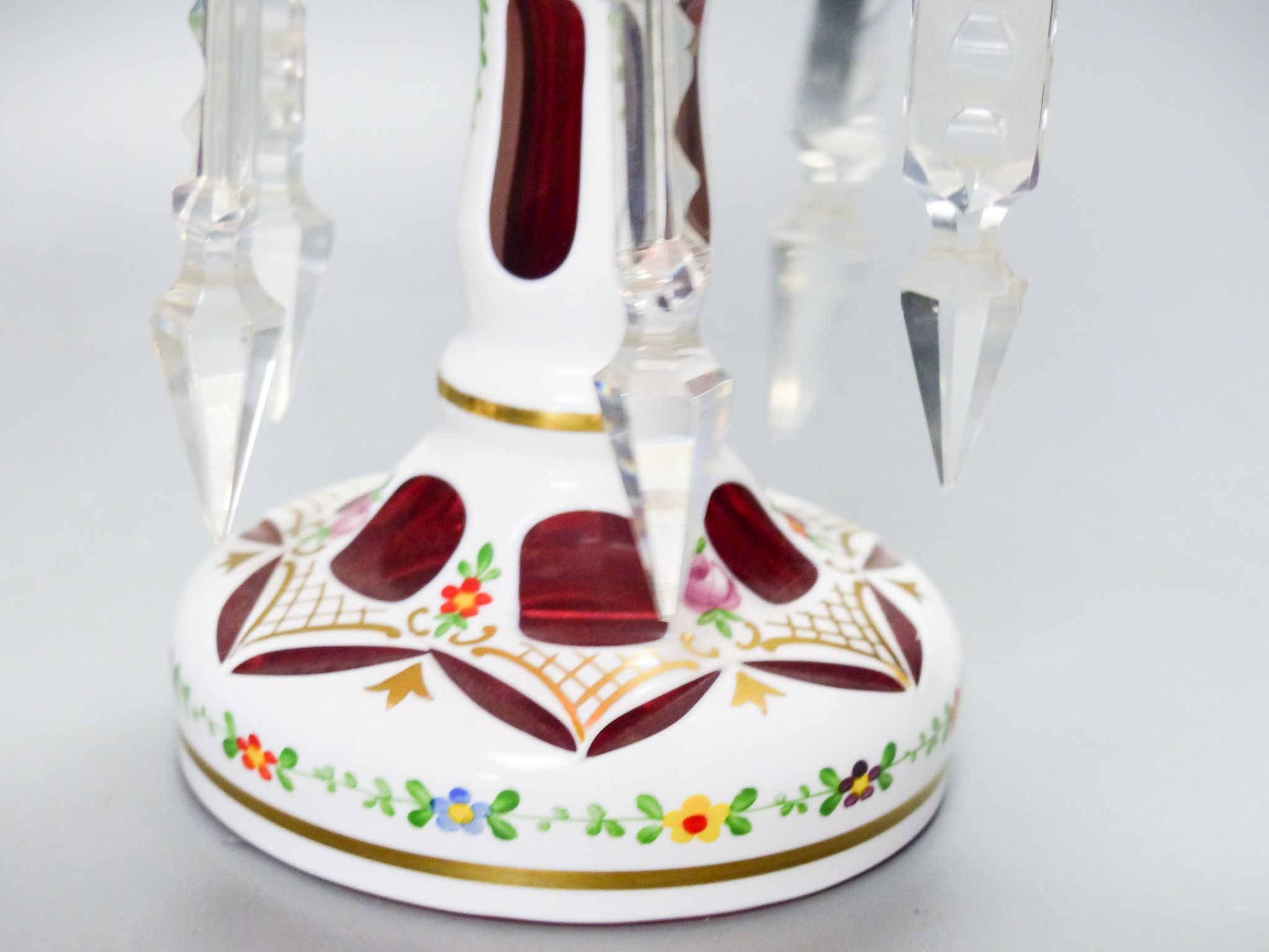 A pair of Bohemian style white and ruby overlaid glass table lustres, 20th century, 20.5 cm high